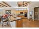 Spacious kitchen with wood cabinets, a granite island, and stainless steel appliances at 23520 N 80Th Way, Scottsdale, AZ 85255
