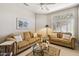 Cozy living room with comfortable seating, a glass table, and plenty of natural light at 23520 N 80Th Way, Scottsdale, AZ 85255