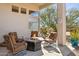 Covered patio features a fire pit, seating, and desert landscaping, creating an inviting outdoor space at 23520 N 80Th Way, Scottsdale, AZ 85255