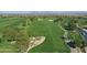Expansive aerial view showcasing the lush golf course, mature trees, and serene desert landscape at 247 E Las Puertas Ln, Queen Creek, AZ 85140
