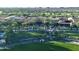 Aerial view of the expansive clubhouse, meticulously landscaped grounds, and golf course at 247 E Las Puertas Ln, Queen Creek, AZ 85140