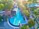 Aerial view of the community pool surrounded by tall palm trees with lounge seating and a pool house at 247 E Las Puertas Ln, Queen Creek, AZ 85140