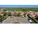 Stunning aerial view of the community and clubhouse with lush landscaping, golf course, and mountain views at 247 E Las Puertas Ln, Queen Creek, AZ 85140