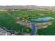 Picturesque aerial view of the golf course community featuring lush greens, ponds, and scenic fairways at 247 E Las Puertas Ln, Queen Creek, AZ 85140