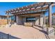 Backyard with pergola and outdoor seating area at 247 E Las Puertas Ln, Queen Creek, AZ 85140