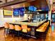 Contemporary bar area showcasing a spacious countertop with comfortable seating and multiple TV screens at 247 E Las Puertas Ln, Queen Creek, AZ 85140