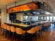 Stylish bar area featuring a large countertop with ample seating and hanging glassware for an inviting atmosphere at 247 E Las Puertas Ln, Queen Creek, AZ 85140