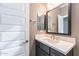 This bathroom features a sink with vanity, door and mirror at 247 E Las Puertas Ln, Queen Creek, AZ 85140