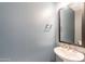 This powder room features blue walls and a pedestal sink at 247 E Las Puertas Ln, Queen Creek, AZ 85140