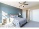 Comfortable bedroom features neutral carpet, ceiling fan, and an accent wall at 247 E Las Puertas Ln, Queen Creek, AZ 85140