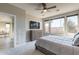 Bedroom featuring a ceiling fan, large window, and sleek dresser at 247 E Las Puertas Ln, Queen Creek, AZ 85140