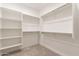 This closet has built-in shelves and multiple hanging racks for optimal storage at 247 E Las Puertas Ln, Queen Creek, AZ 85140
