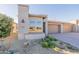 Charming home with well-manicured landscaping, a three-car garage, and a welcoming front entrance at 247 E Las Puertas Ln, Queen Creek, AZ 85140