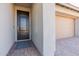 Inviting front entrance with a sleek black door, stylish brick walkway, and access to the garage at 247 E Las Puertas Ln, Queen Creek, AZ 85140