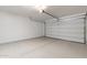Clean and spacious garage with a modern epoxy floor, ready for customization and vehicle parking at 247 E Las Puertas Ln, Queen Creek, AZ 85140