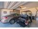 Organized garage featuring ample storage and parking, highlighted by a golf cart and a Buick sedan at 247 E Las Puertas Ln, Queen Creek, AZ 85140