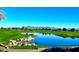 Scenic golf course view with tranquil pond and lush green fairway and mountain views at 247 E Las Puertas Ln, Queen Creek, AZ 85140