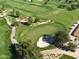 Scenic aerial view of a well-maintained golf course with green fairways and sand traps at 247 E Las Puertas Ln, Queen Creek, AZ 85140