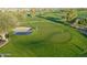 Close-up aerial view of a lush golf course putting green with sand trap at 247 E Las Puertas Ln, Queen Creek, AZ 85140