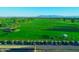 Scenic golf course with lush green fairways, mountain views, and a line of golf carts at 247 E Las Puertas Ln, Queen Creek, AZ 85140