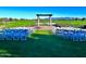 Outdoor wedding venue with chairs overlooking lush golf course and mountains at 247 E Las Puertas Ln, Queen Creek, AZ 85140