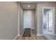Bright hallway with wood-look floors, neutral walls, and access to other rooms in the home at 247 E Las Puertas Ln, Queen Creek, AZ 85140