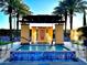Charming hot tub area with shaded seating, lounge chairs, and blue tile accents in a welcoming community space at 247 E Las Puertas Ln, Queen Creek, AZ 85140