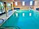 Bright indoor pool area featuring large windows and plenty of space to relax and unwind at 247 E Las Puertas Ln, Queen Creek, AZ 85140