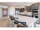 Modern kitchen with white quartz countertops, stainless steel appliances, and breakfast bar at 247 E Las Puertas Ln, Queen Creek, AZ 85140