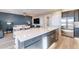 Open concept kitchen with large center island and stainless appliances overlooking living area at 247 E Las Puertas Ln, Queen Creek, AZ 85140