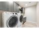 Laundry room features washer, dryer, countertops and cabinets at 247 E Las Puertas Ln, Queen Creek, AZ 85140