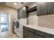 Laundry room features washer, dryer, countertops and cabinets at 247 E Las Puertas Ln, Queen Creek, AZ 85140