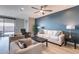 Bright living room boasts a modern ceiling fan and a stylish accent wall at 247 E Las Puertas Ln, Queen Creek, AZ 85140