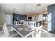 Bright open-concept living room, dining area and kitchen featuring stainless steel appliances and modern finishes at 247 E Las Puertas Ln, Queen Creek, AZ 85140