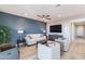 Stylish living room with a modern ceiling fan, comfortable seating, and a large TV at 247 E Las Puertas Ln, Queen Creek, AZ 85140