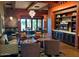 Comfortable lounge area with stylish seating, custom shelving with wine display, and open layout at 247 E Las Puertas Ln, Queen Creek, AZ 85140