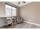 Cozy office space with a large window providing natural light, desk, and comfortable seating at 247 E Las Puertas Ln, Queen Creek, AZ 85140