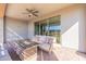 Covered patio features a ceiling fan, outdoor furniture and fire pit at 247 E Las Puertas Ln, Queen Creek, AZ 85140
