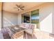 Inviting covered patio with a ceiling fan, comfortable seating, and a charming fire pit for outdoor enjoyment at 247 E Las Puertas Ln, Queen Creek, AZ 85140