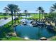 Scenic pond with waterfalls, rocks, and palm trees alongside the golf course at 247 E Las Puertas Ln, Queen Creek, AZ 85140