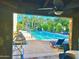 Outdoor community lap pool lined with lounge chairs and umbrellas viewed from a cabana at 247 E Las Puertas Ln, Queen Creek, AZ 85140