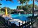 Beautiful community pool features lounge chairs, umbrellas, and a pool house with shaded seating area at 247 E Las Puertas Ln, Queen Creek, AZ 85140