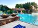 Picturesque community pool with fire bowls, fountains, pool house, and resort-style amenities for residents at 247 E Las Puertas Ln, Queen Creek, AZ 85140