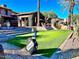Backyard putting green with flag and golf bag at 247 E Las Puertas Ln, Queen Creek, AZ 85140