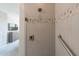 The shower features decorative tile, a glass door, built-in bench, and grab bar at 247 E Las Puertas Ln, Queen Creek, AZ 85140