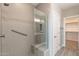 The shower features decorative tile, a glass door, built-in bench, and grab bar at 247 E Las Puertas Ln, Queen Creek, AZ 85140
