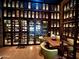Impressive wine room featuring custom-built shelving, a convenient ladder, and an inviting table for sophisticated tastings at 247 E Las Puertas Ln, Queen Creek, AZ 85140