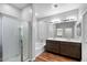 Bathroom with double sink vanity, soaking tub, and glass-enclosed shower at 24868 W Kowalsky Ln, Buckeye, AZ 85326