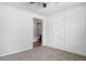 Bedroom with accent wall, ceiling fan, and view of adjacent bathroom at 24868 W Kowalsky Ln, Buckeye, AZ 85326
