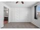 Bedroom with stylish accent wall, carpeted floor, window, and neutral paint at 24868 W Kowalsky Ln, Buckeye, AZ 85326
